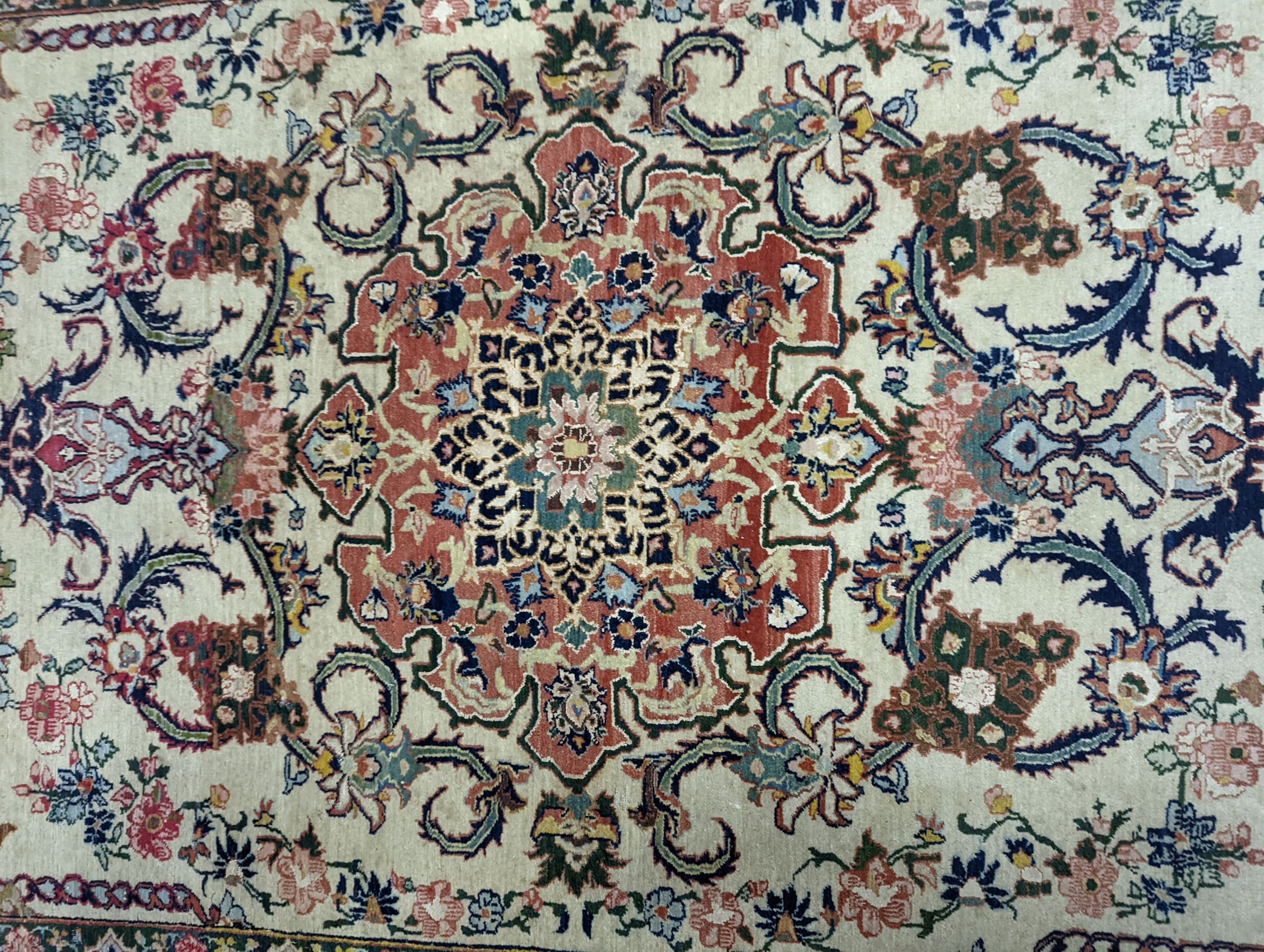 A part silk Isfahan cream rug with central floral scroll medallion, 196 x 140cm